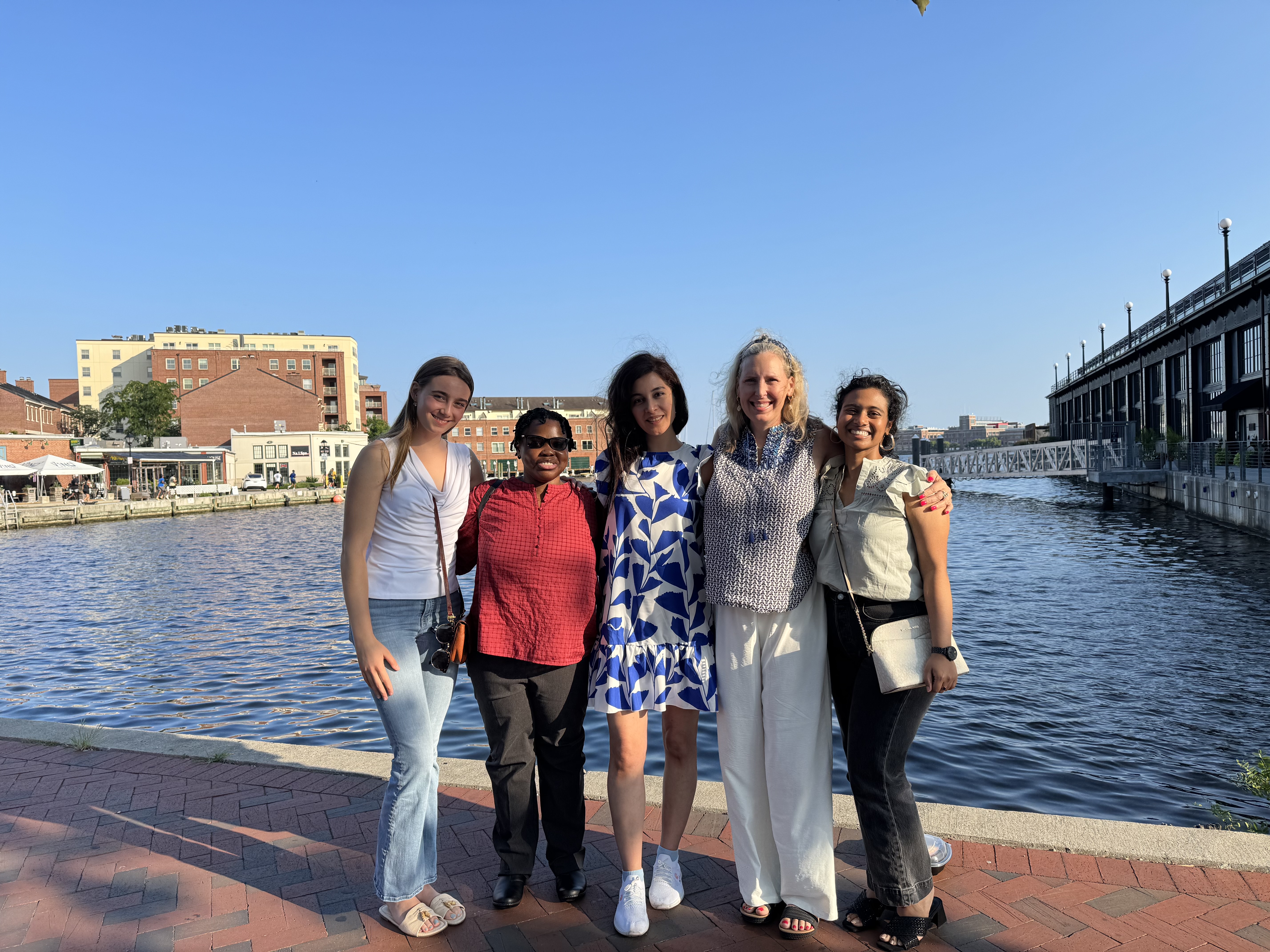 The alt text for the image is "Multi-colored capsules in a dish on white background."